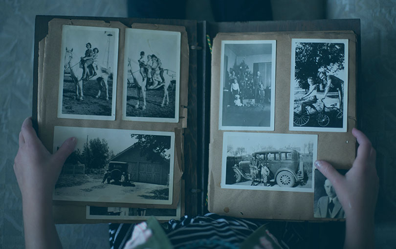 A scrapbook from perhaps 1950 being held on a person's lap