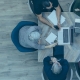 Overhead photo of five people sitting at a table in an office
