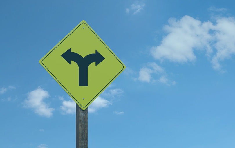 A road sign indicating a branching of the road