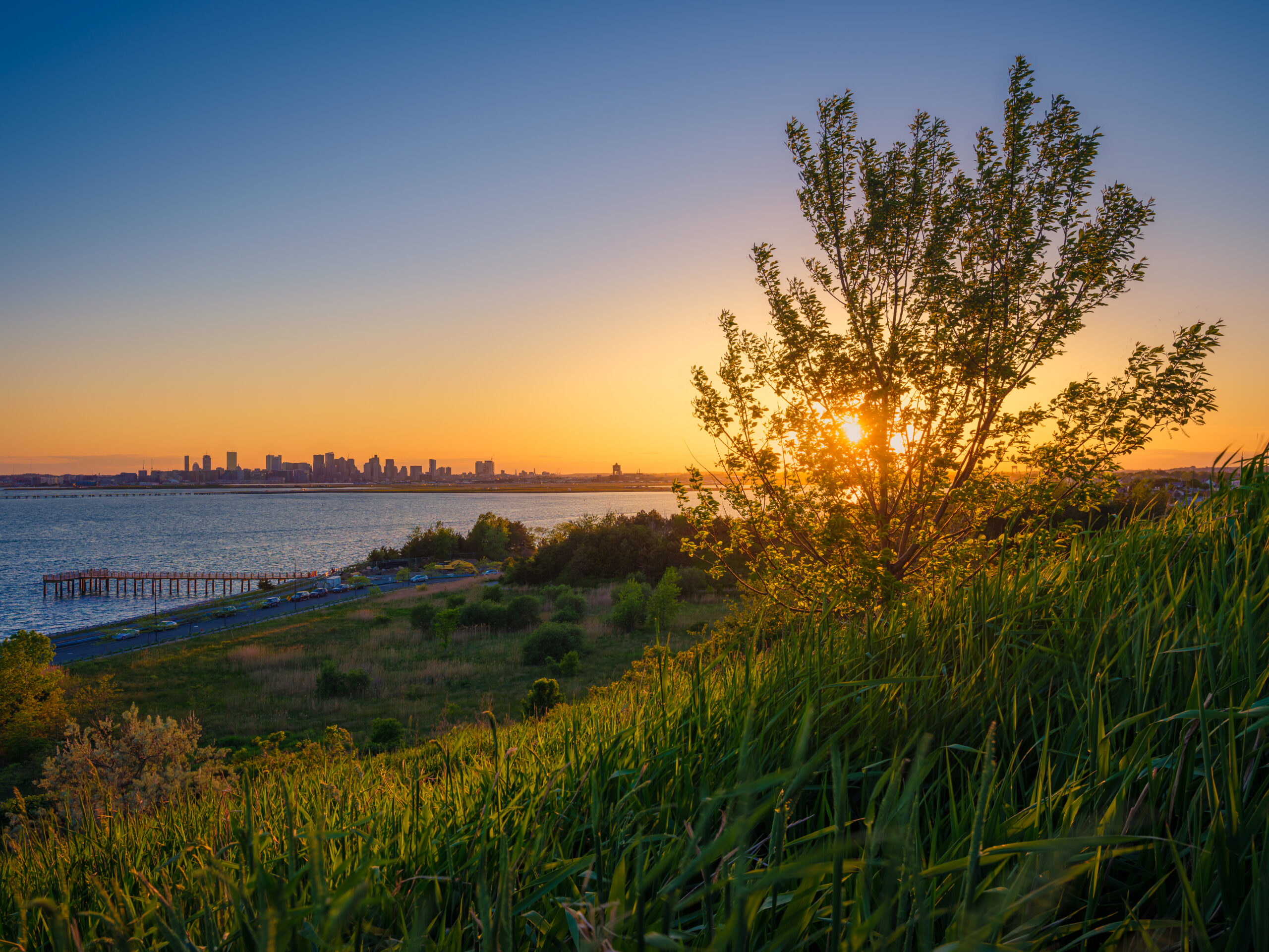 Sunset View of the Ocean with a City in the Background