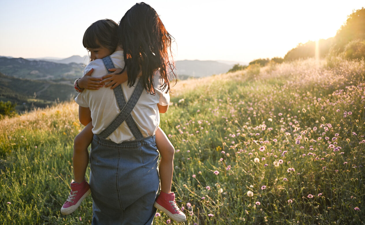 Woman Holding Child in a Meadow