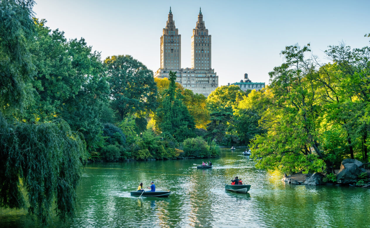 People in Boats on a River in Front of a Building