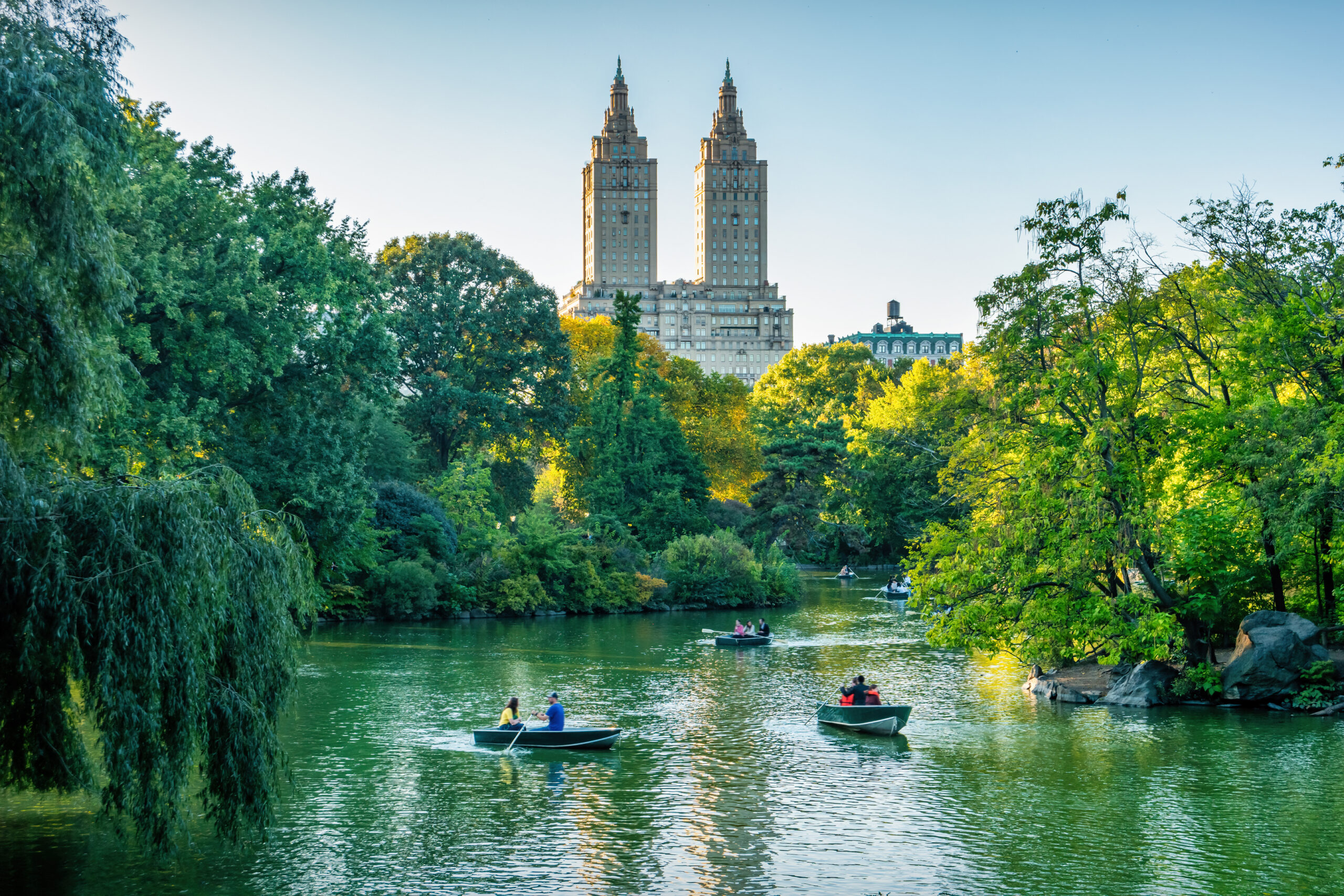People in Boats on a River in Front of a Building