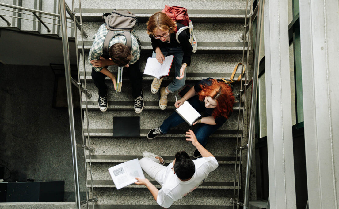 overhead view of college students sitting in a stairwell