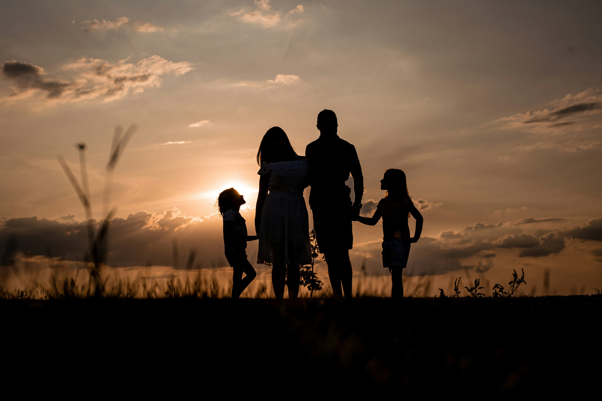 silhouette of family at sunset